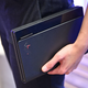 Despite being a bit on the thick side, in hand, there’s something that just feels natural about the X1 Fold’s dimensions and exterior leather cover.
